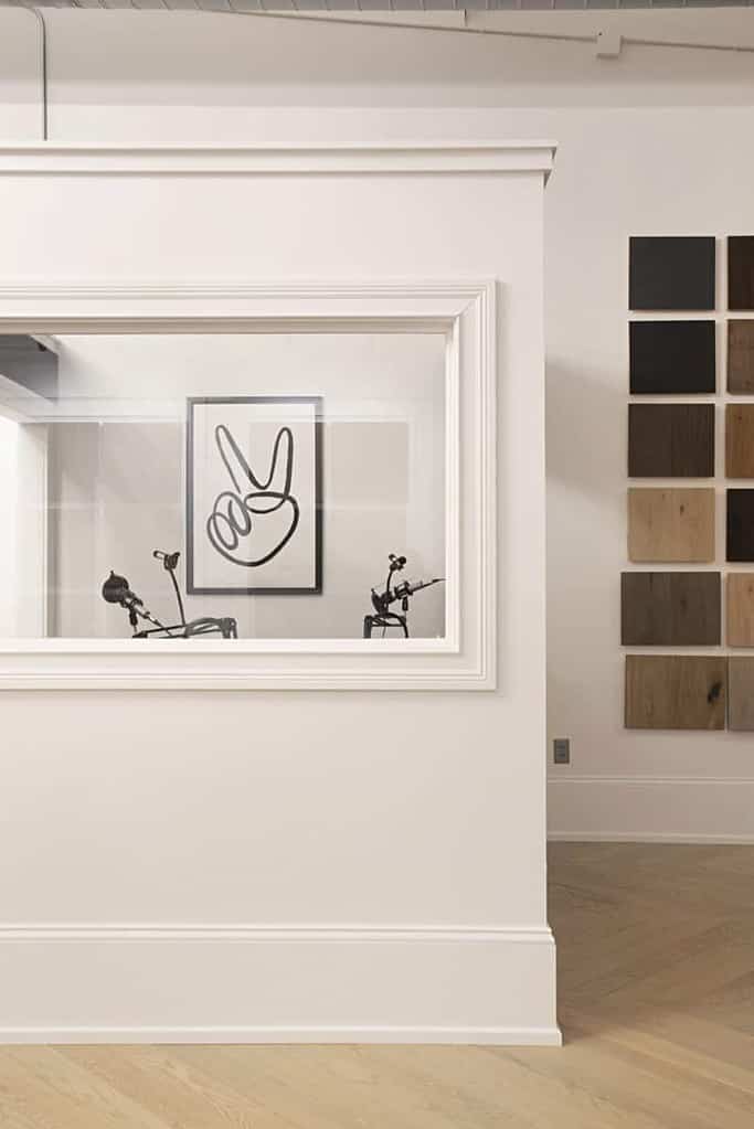 A rectangular picture frame hangs on the wall, showcasing a piece of art that adds to the interior design of the room.