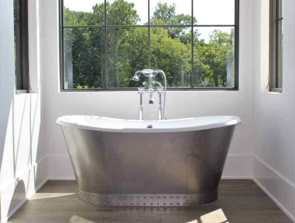 A plumbing fixture with a tap is installed in a bathroom window, providing a sink and bathtub with the necessary plumbing accessories for a house.