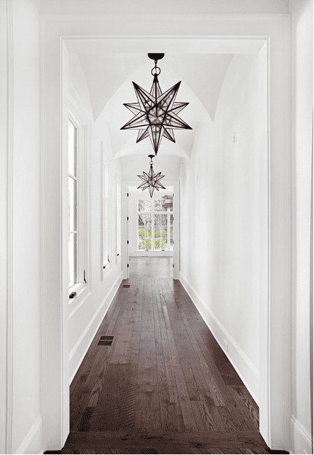 The chandelier illuminates the hallway.