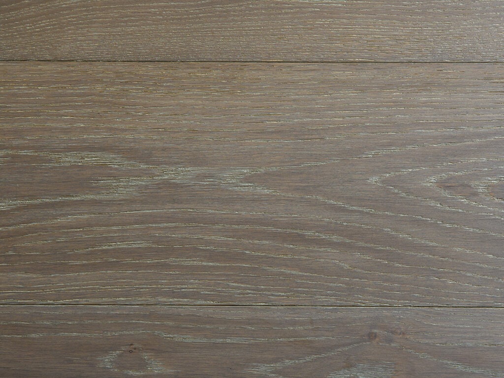 The image shows a close-up texture of dark brown wooden planks with prominent, straight grain patterns and some knots, likely used for flooring or paneling.