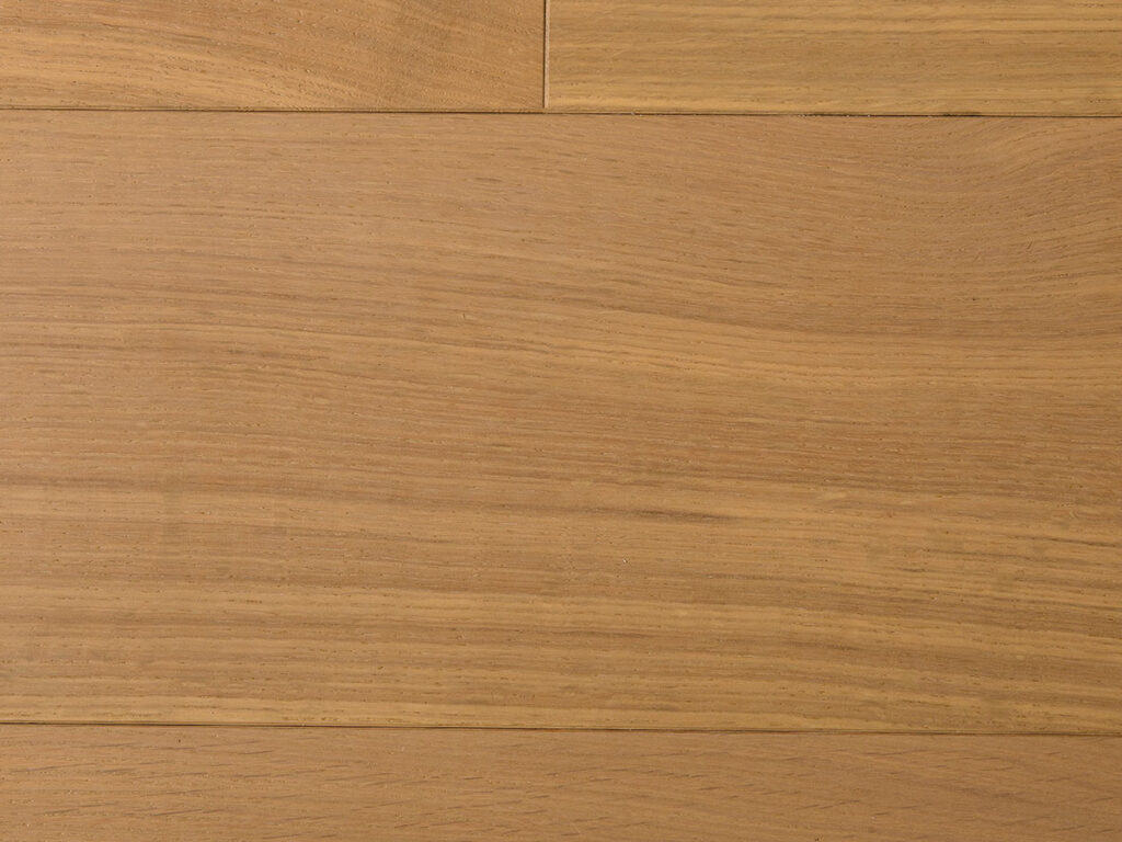 This image shows a section of smooth wooden flooring or paneling with a warm, light brown color and visible natural grain patterns.